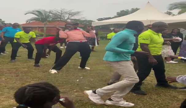 Adults participating in a lively outdoor game during the church Cell Day