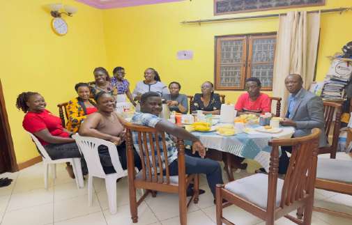 Church members seated around a dining table during home-cell fellowship